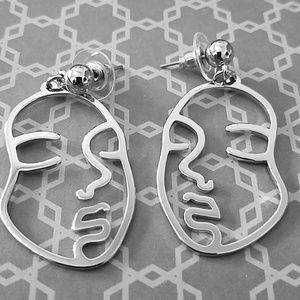 Abstract cut out metal face earrings